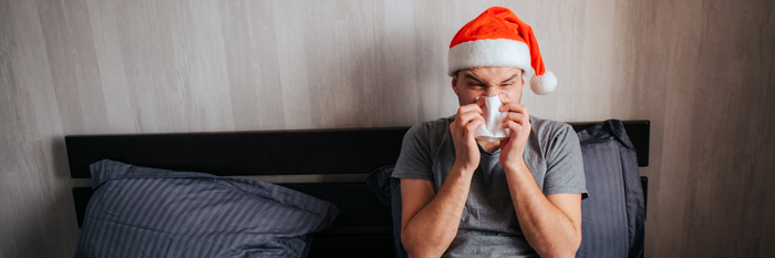 man blowing nose holidays