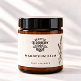 Goodnight Magnesium Balm jar with the Seattle Elderberry label on cream linen (concept render)